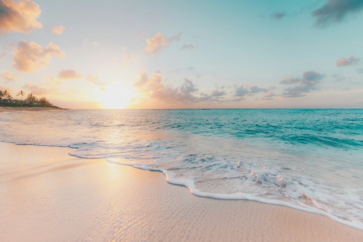 Turquoise water meeting a white beach